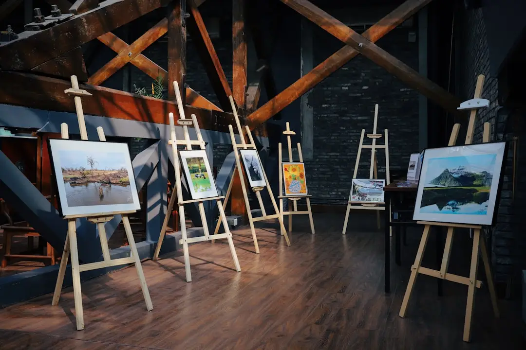 five assorted paintings on easels